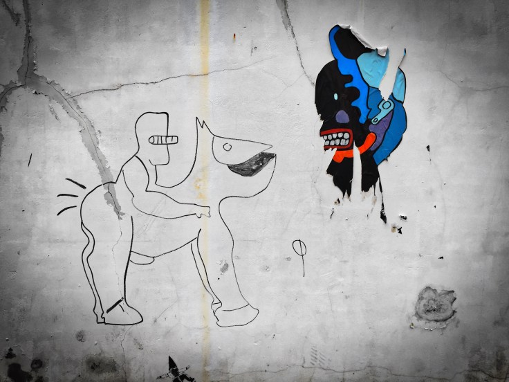 Teken aan de wand #62 Masker. Tienen, Broekstraat, 29 november 2015, Foto Hendrik Elie Vanden Abeele. Te Voet in de Stad